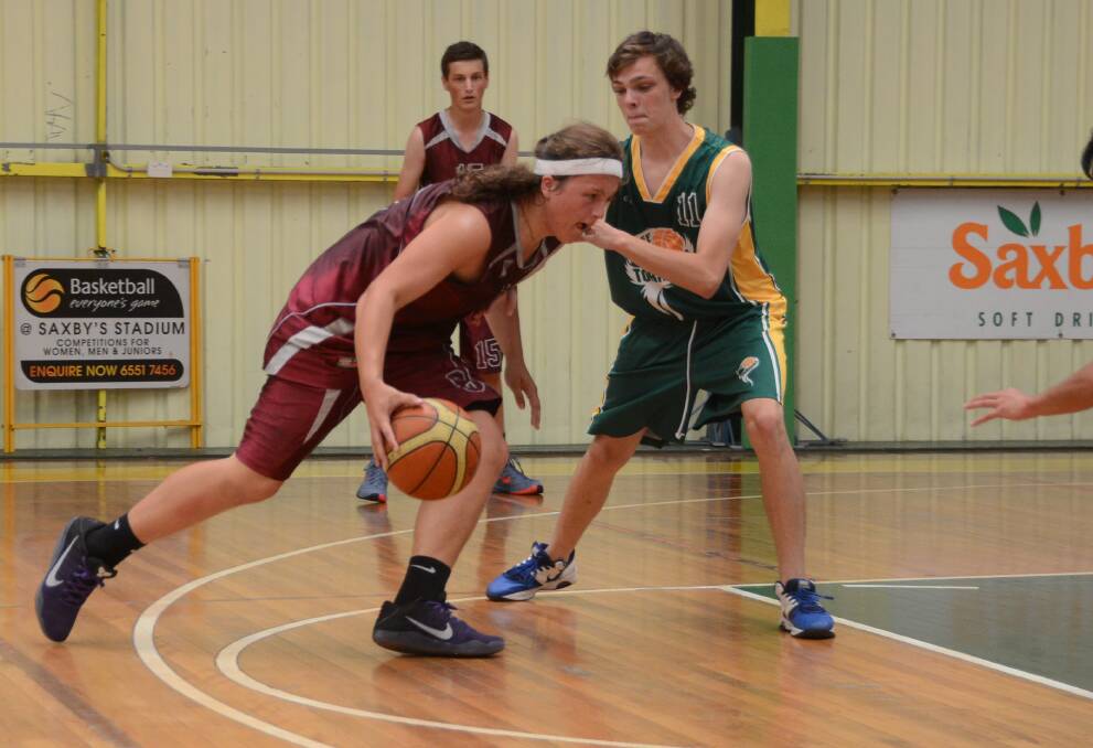 Brody Doughtery tries to work his way through the Taree defence during a clash in the Taree-Gloucester basketball challenge played at Taree.