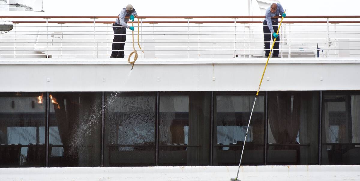 SWAB THE DECKS: Crew of P&O's Pacific Eden clean and disinfect the ship at Sydney's White Bay Cruise Ship Terminal after its return from a cruise impacted by a gastric virus. Picture: Wolter Peeters, SMH.