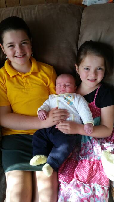 Lauryn and Lucy Coulson with baby brother Jonathon.