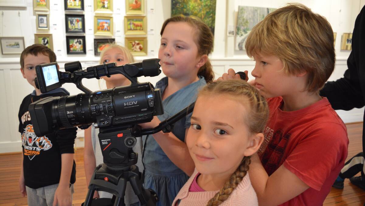 Abbie Cross, Isabella Parker and Quinlan Collins work together to film an interview asking "What do you like most about living in Gloucester?"