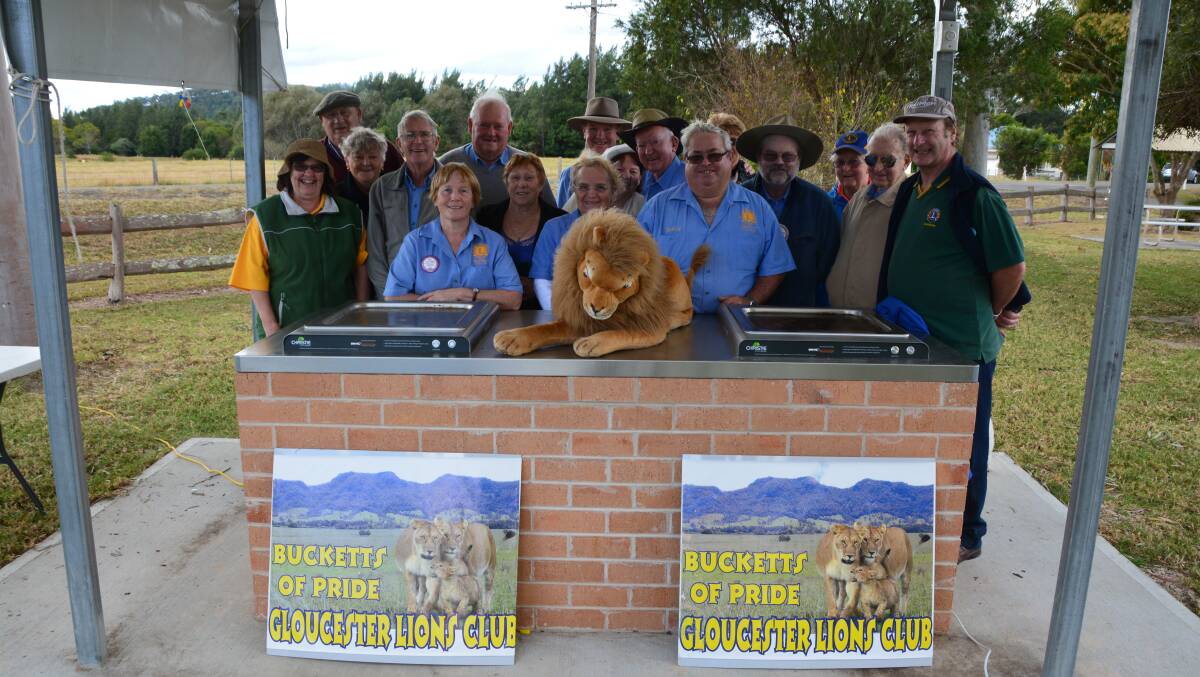 Gloucester Lions Club members throw a free sausage sizzle for the community to celebrate the opening of the new electric barbecue.
