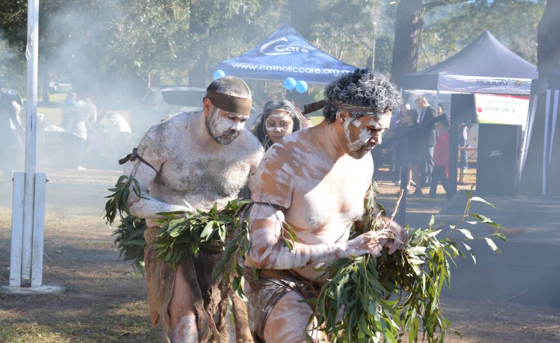 Biripi dancers from Taree perform a welcoming dance while cleansing the air with gum leaves.