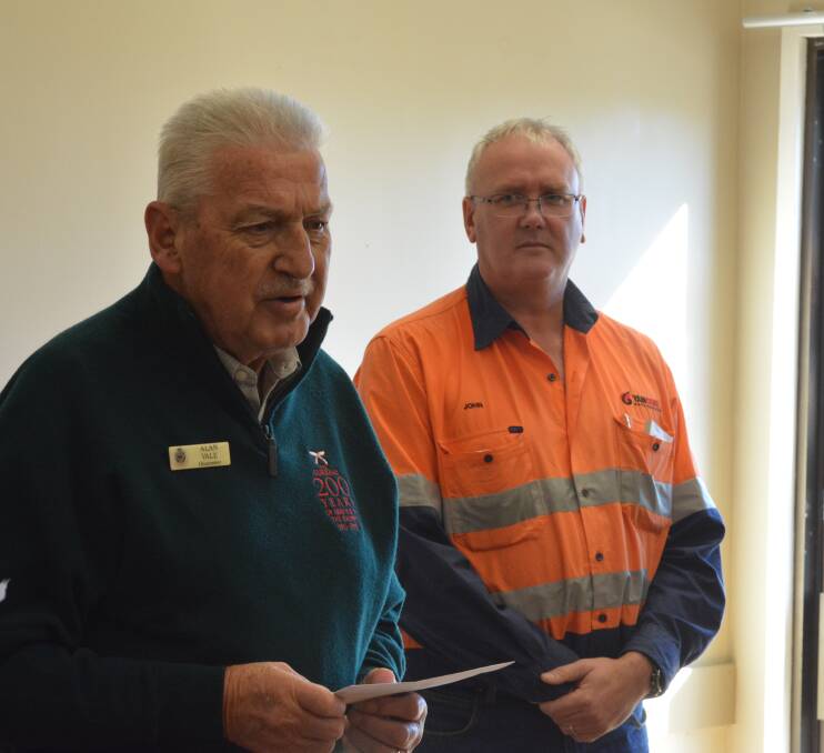 Gloucester RSL Sub Branch president Alan Vale accepts funds from John Cullen Stratford Coal Operations manager to purchase new chairs. 