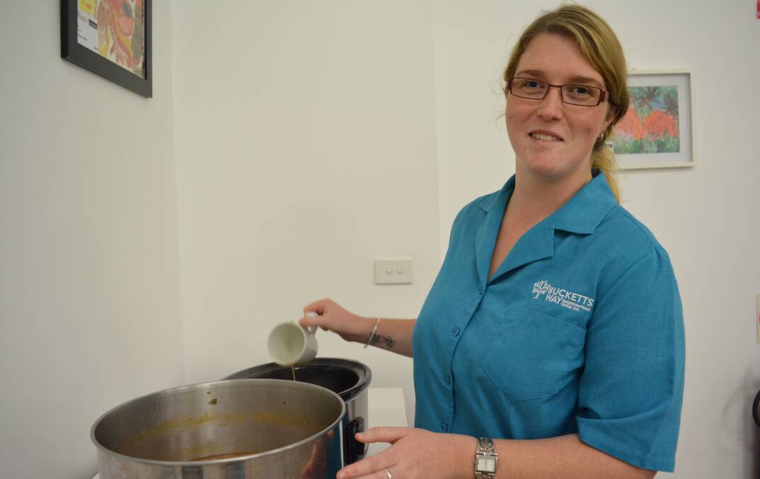 Rachel Laurantus transfers the yummy soup into a slow cooker to keep it nice and hot for all to enjoy.  