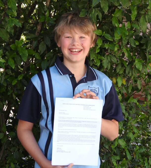 Quinlan Collins was presented his Newcastle Permanent Primary Mathematics Competition at a recent school assembly. Photo supplied.