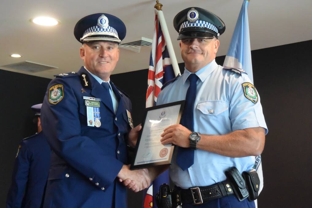 Peter Thurtell presents the Northern Region Commander's Certificate of Merit to Senior Constable Robin Crick. Picture: Laura Polson