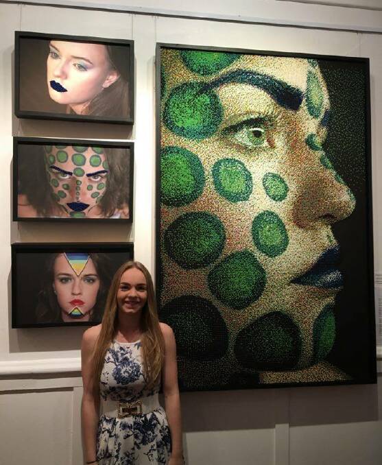So many faces: Year 12 student, Leah Yarnold stands with her display during the opening night of the HSC exhibition held in the gallery. Picture: Supplied