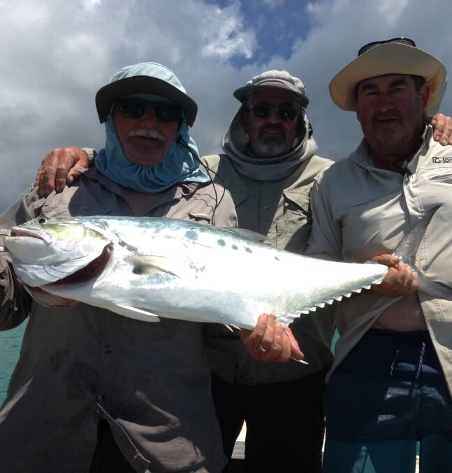 It was this big: Andrew Henderson, Gary Spokes and Dick Baker with the Queenfish they caught at Blue Mud Bay off Coburg peninsula. Picture: Supplied