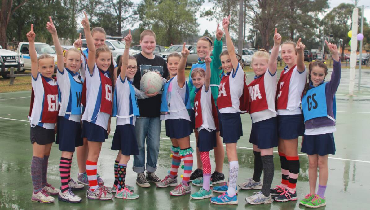 The Gloucester netball junior girls play in the rain with their crazy, colourful socks and wild, wacky hair to help raise money for Toot.