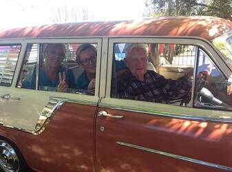 Tom Donoghue (Kimbarra resident) in the driver’s seat of the 1959 FC Holden station wagon, with Mandy Wilson (staff) and Kellie Young (staff) in the rear seat. Photo. Supplied