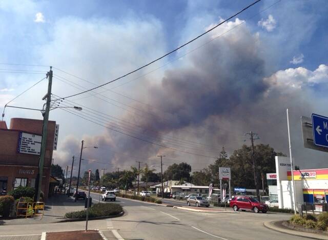 Smoke billowing through Tuncurry's main street on Wednesday afternoon. Photo by Scott Calvin.