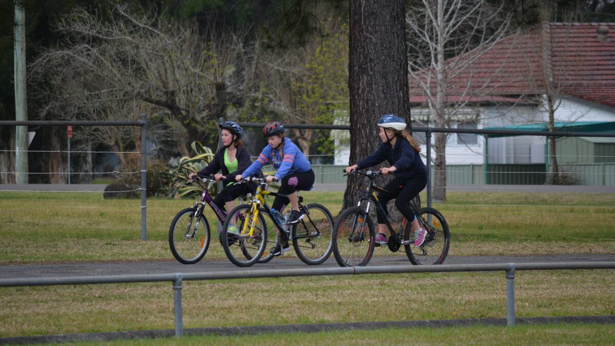 Training for the race: Year 7 and 8 students cycle by the Recreation Centre on their way to the Bucketts Lookout as part of their training for the Tri Challenge.