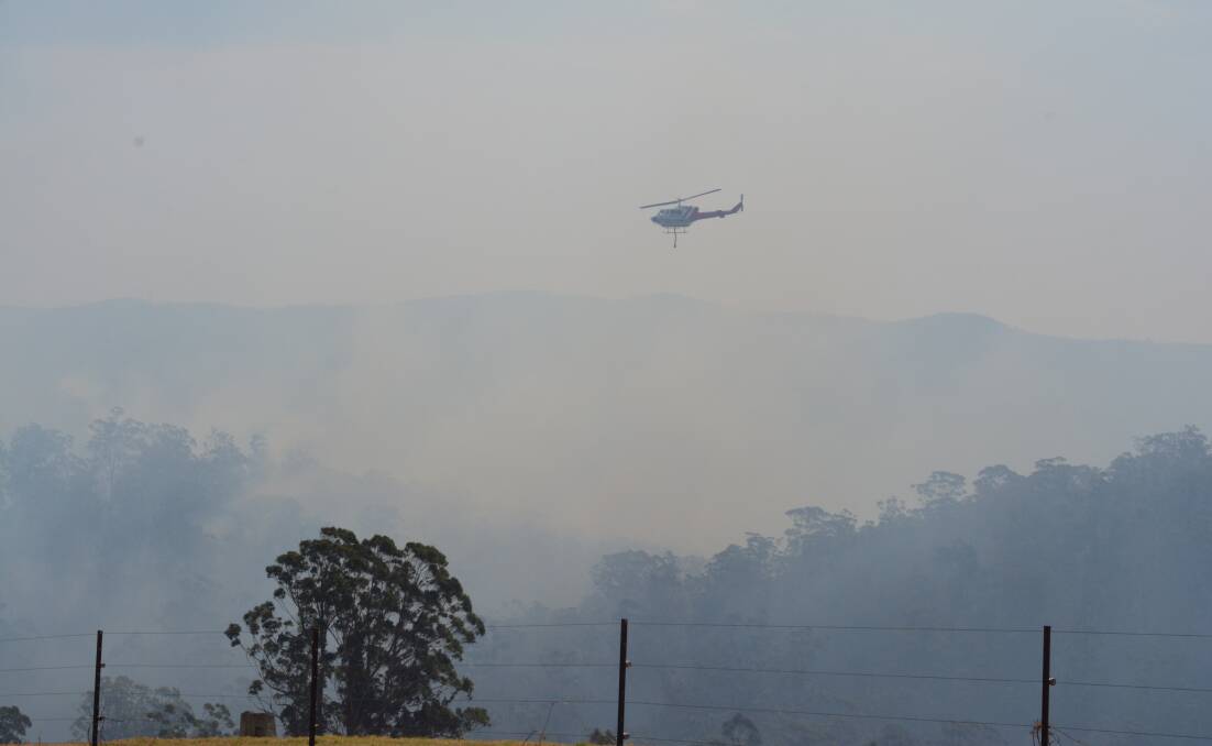 Helicopter water bombing the fire in Belbora, east of Gloucester. Photo. Anne Keen