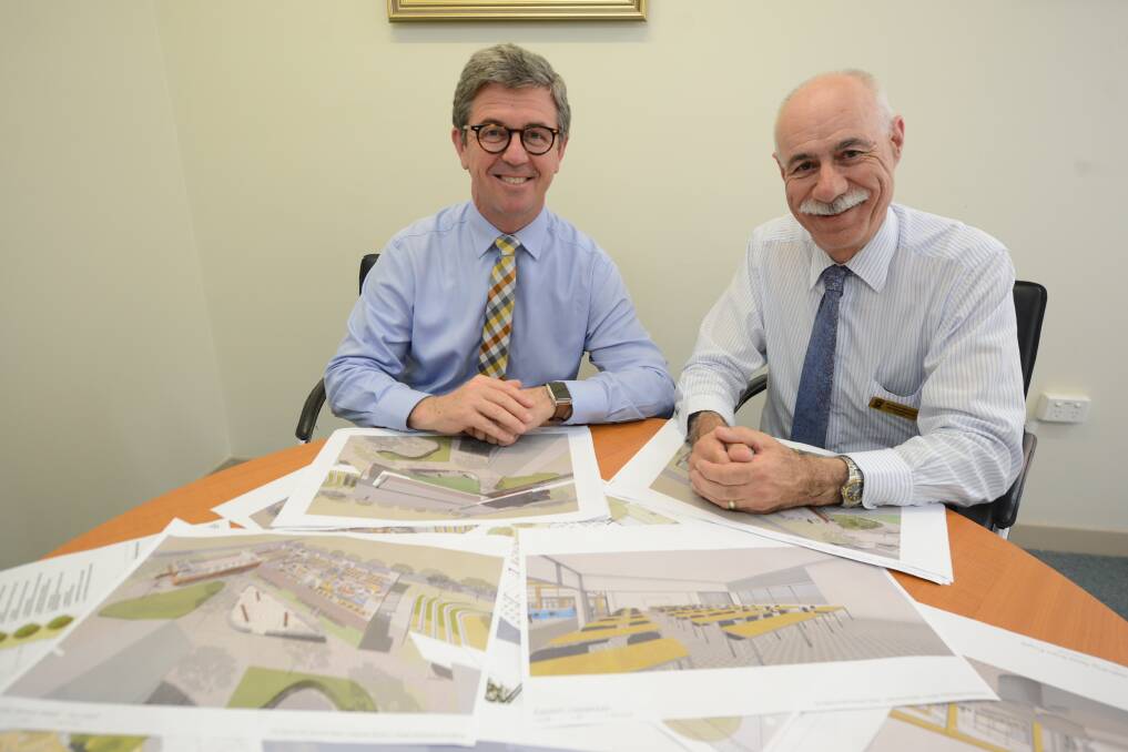 Looking at plans: Federal member for Dr David Gillespie and principal of St Clare’s Peter Nicholson look over the artist's impression of the new $4.89-million building for the school. 
