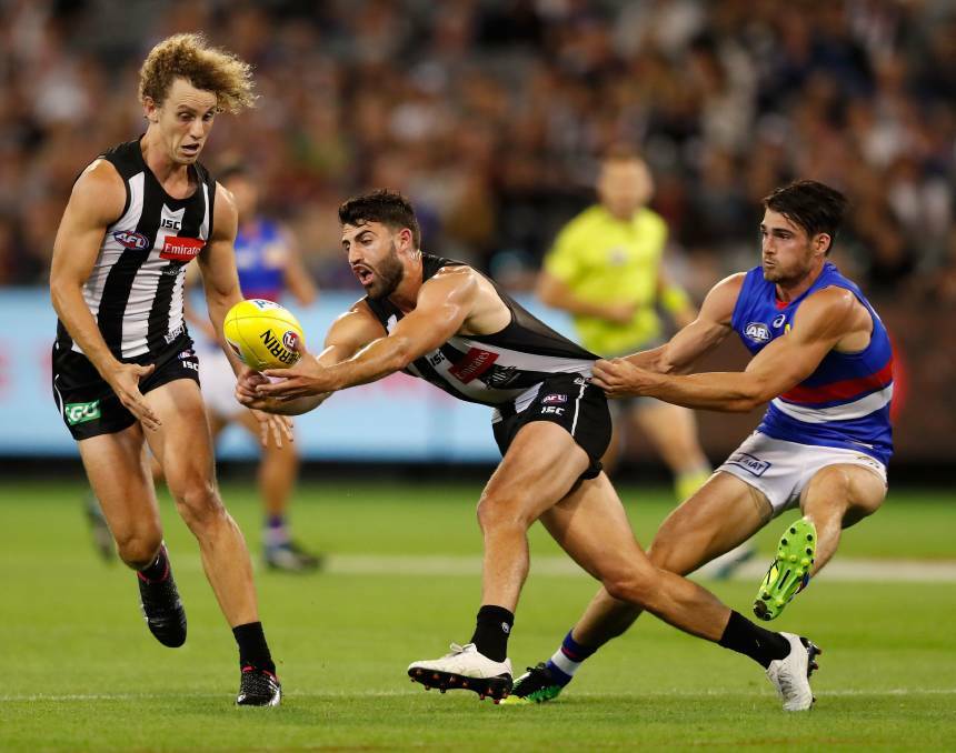 MORE PHOTOS | Alex Fasolo of the Magpies is tackled by Easton Wood of the Bulldogs. Hit the image to see more ...