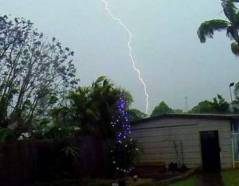 Lightning competed with Christmas lights in this backyard.  Photo taken by @physhopath of the recent storm over Port Macquarie.