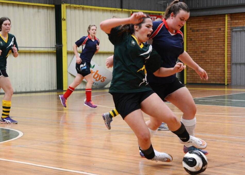 Rosie White and Thea Wespi clashed during the St Clare's/Wingham High futsal match at Saxby s Stadium.