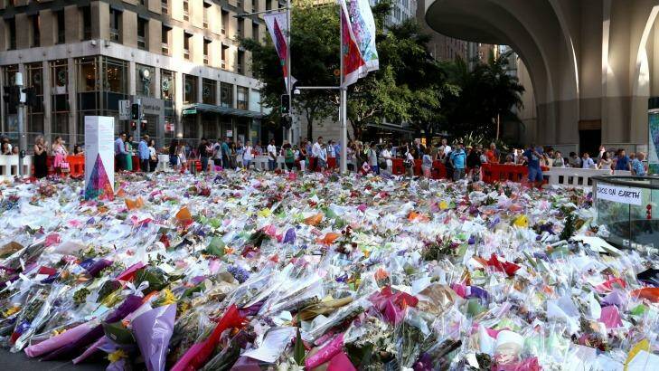 People line up to leave their flowers at Martin Place. Photo: James Alcock