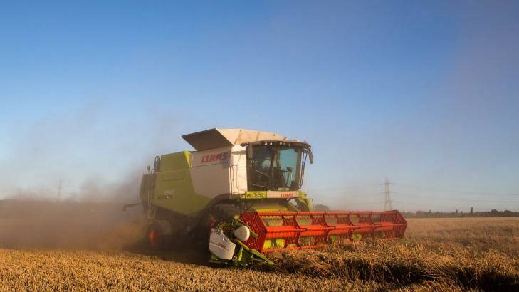 After the dairy farmers media opportunity, the background for the next rural double header by the Prime Minister and his deputy could be a combine harvester. Photo: Jason Alden