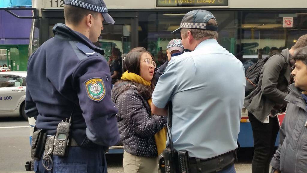 Police order a young woman outside the Sydney Apple store to move on. Photo: Hannah Francis