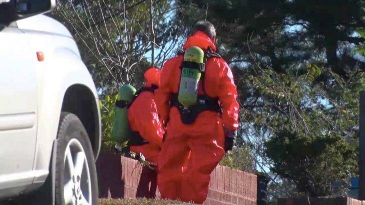 Hazmat specialists wear jumpsuits and oxygen tanks to examine the chemicals. Photo: Top Notch Video
