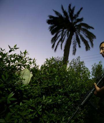 Defending Iraq: A fighter with the Shiite Imam Ali Brigade guards its headquarters in Baghdad. Photo: Kate Geraghty