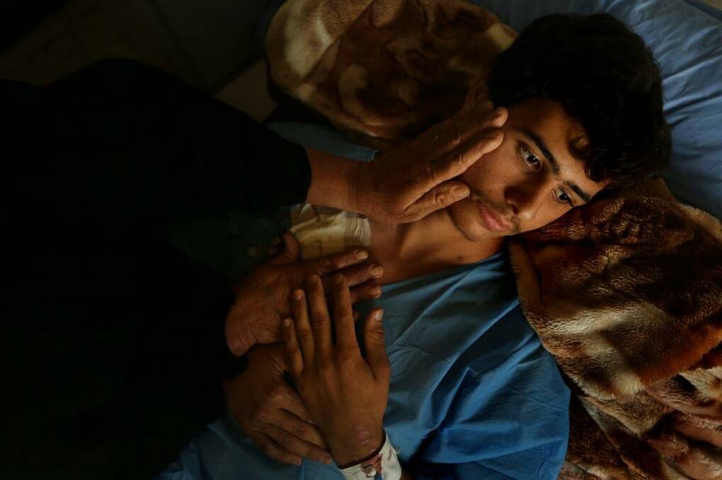 Volunteer fighter Ismail Abdul Hassan, 17, recovers in Baghdad's al-Wasiti hospital after being wounded by an improvised explosive device while patrolling Baghdad's hinterland. Photo: Kate Geraghty
