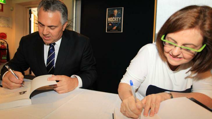 Sign of approval: Joe Hockey and writer Madonna King autograph the tome.  Photo: James Alcock/Getty Images