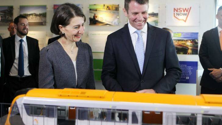 All aboard: Mr Baird and Ms Berejiklian study a model of the new trains. Photo: Natalie Roberts