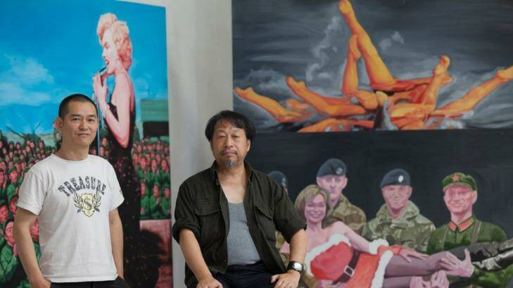 Chinese-Australian artists Guo Jian (left) and Shen Jiawei with Guo's work in Guo's Beijing studio. Photo: Ricky Wong