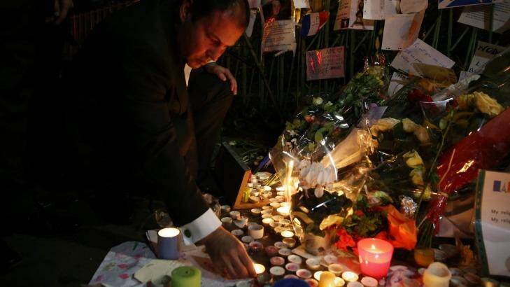 Josh Frydenberg placed flowers and lit a candle at the Bataclan memorial in Paris during a recent visit. Photo: Andrew Meares