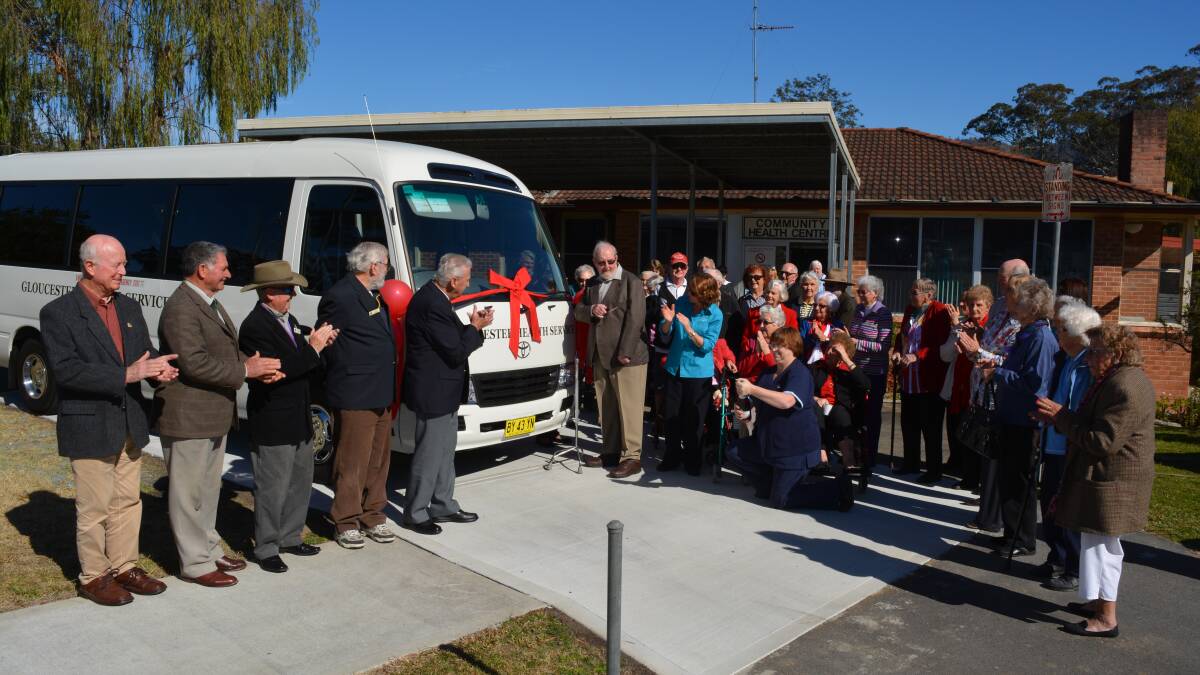 Geoff Teece cuts the ribbon to welcome the new Gloucester Activities Centre bus into active service.