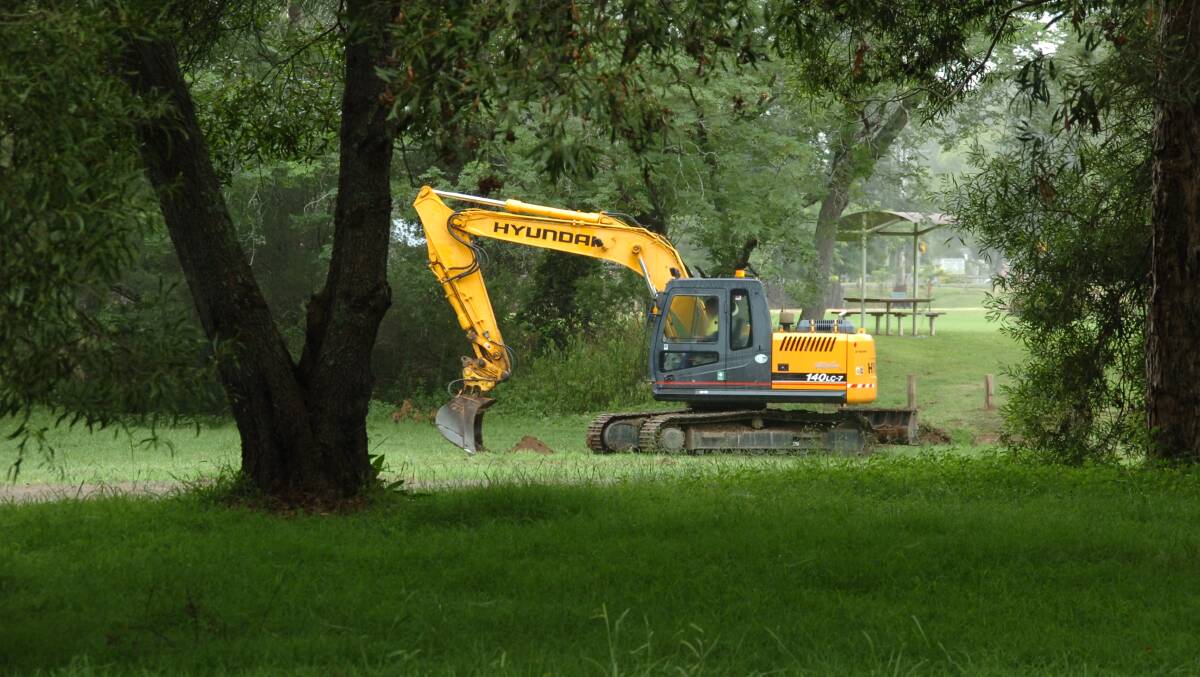 An excavator working to improve river access in Gloucester District Park.