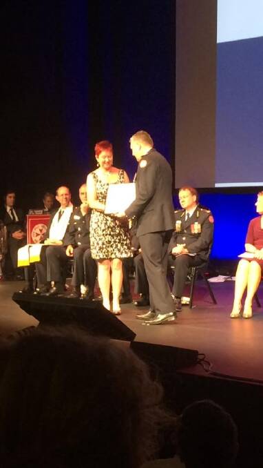 Jan Tresidder receives her award from the NSW Ambulance Association at the Opera House.