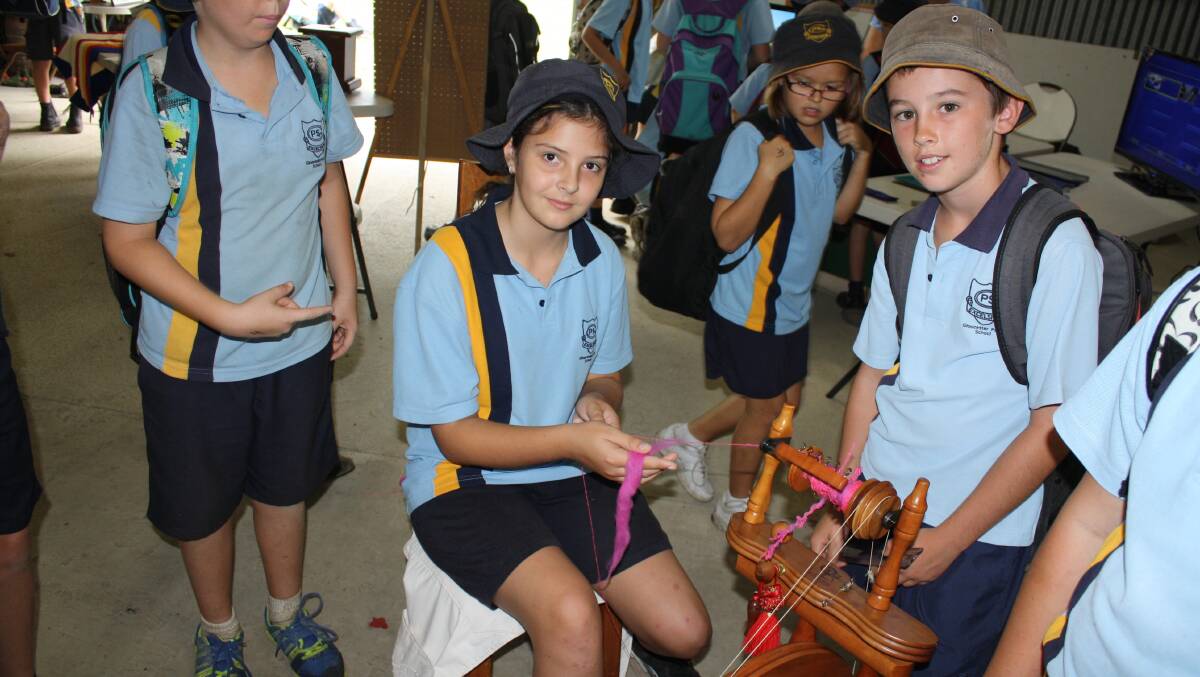 Gloucester Public students Hayley Weismantel and Harry Moore with a spinning wheel.