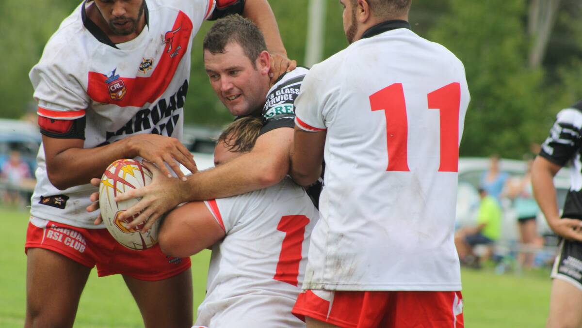 Mathew Higgins is wrapped up by the Karuah defence.