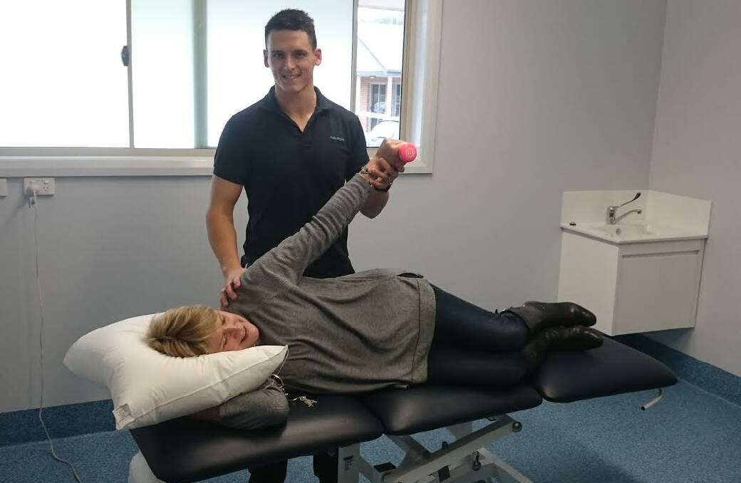 More services: Physiotherapist Aaron Bayley works with patient Liane Markey.