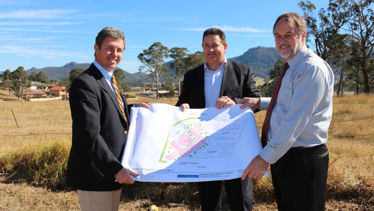 Lyne MP David Gillespie, Nambucca Valley Care chief executive John Butler and Gloucester Shire Council general manager Danny Green look over plans for a new aged care facility in Gloucester earlier this year.