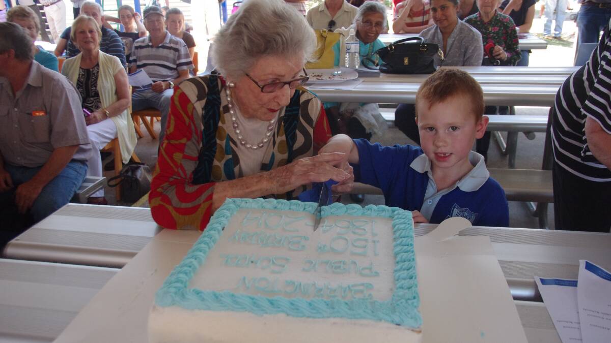 96-year-old former student Gwen Street (nee Taylor) cuts the 150th birthday cake with 
five-year-old current student Joshua Jones.