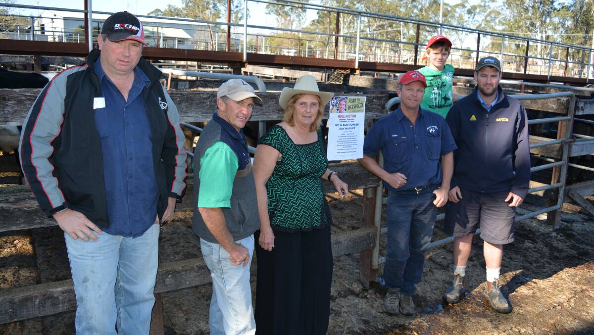 Jason Collins, James Laurie, Rosie Everett, Chris Maslen, Nicholas Maslen and Mathew Higgins at the saleyards for the Curtis Landers fundraising auction on Thursday. 