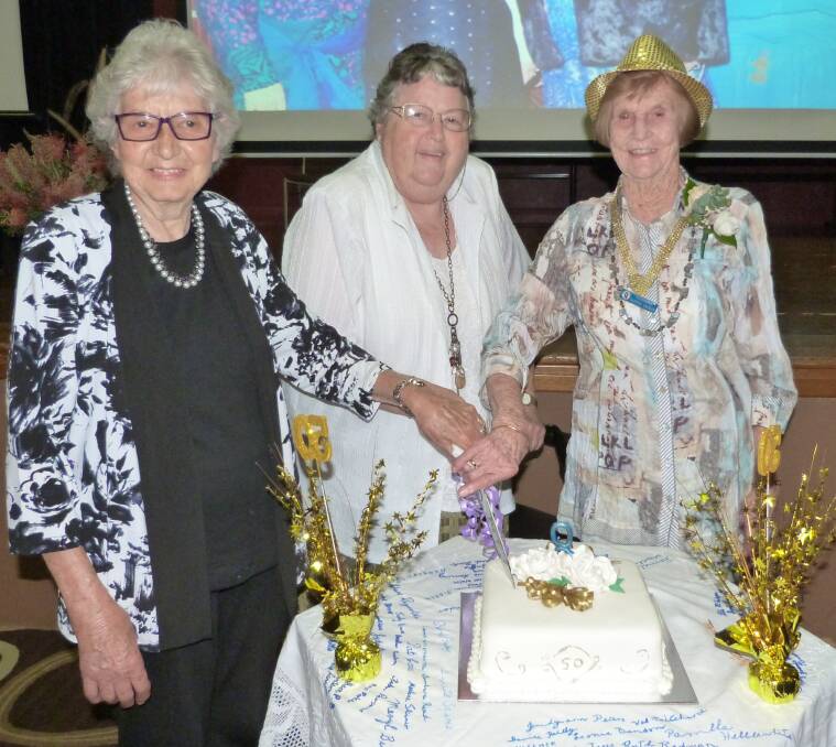 Celebrations: Charter members of Gloucester Quota, Norma Wilson, Peg Graham and Daphne Croker cutting the 50th birthday cake.