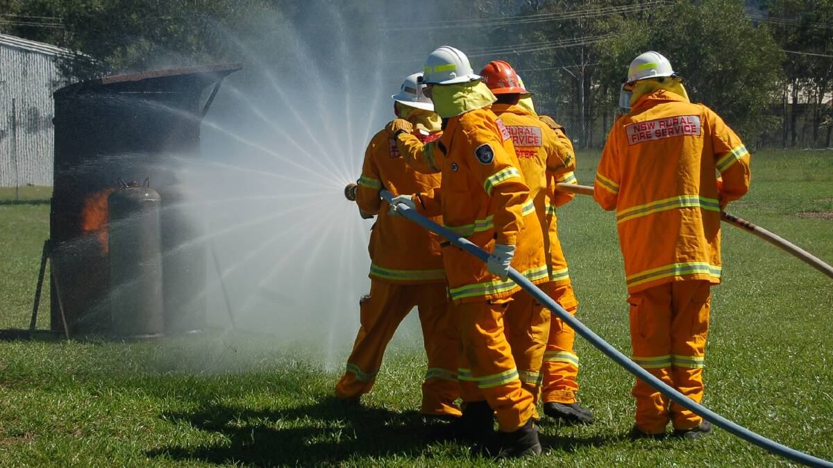 Fire-fighters participate in a simulated five-man fog attack to retrieve a patient.