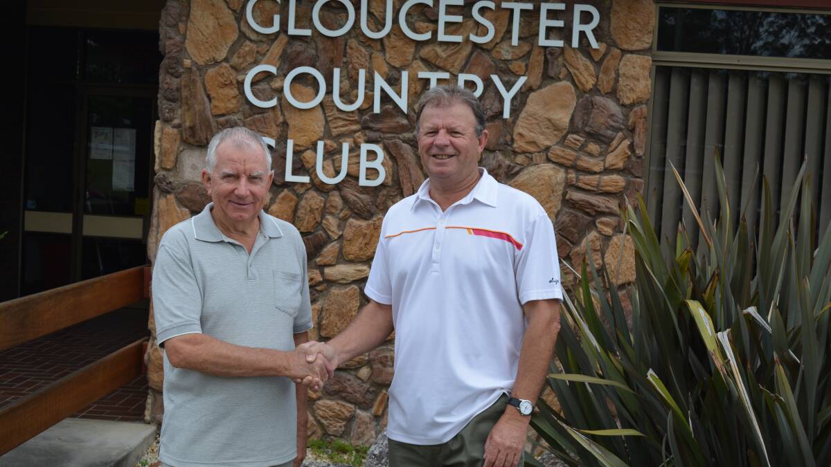 Dave Mann is congratulated by new club president Wayne Maddalena on his life membership.