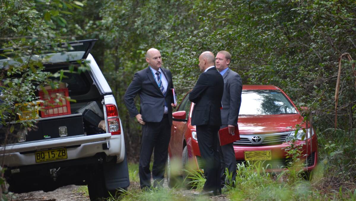The investigator in charge of the case, Detective Inspector Gary Jubelin, middle, near Queens Lake during a search south of Port Macquarie earlier this year.