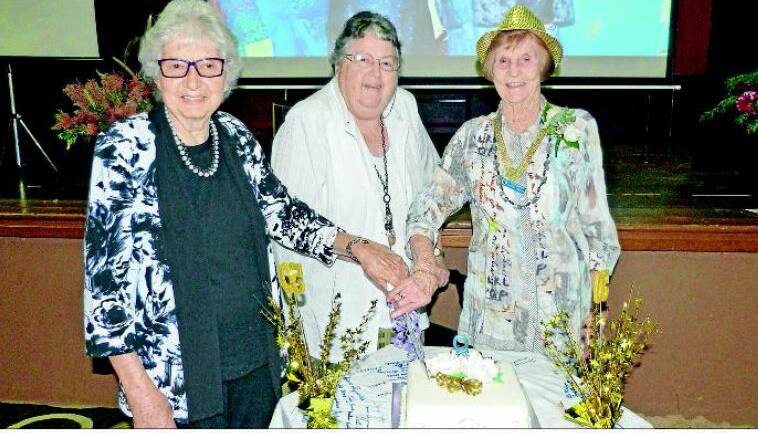 Gloucester Quota charter members Norma Wilson, Peg Graham and Daphne Croker cut the 50th birthday cake.