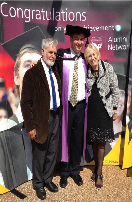 Dr Martin Murray, flanked by his parents John and Beverley.