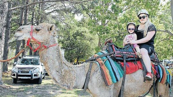 Sisters Matilda and Emma Green take a camel ride
