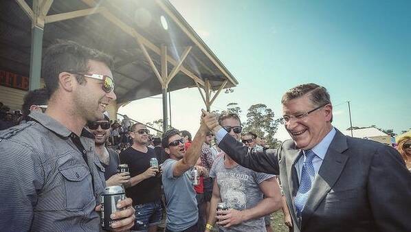 Winners are grinners: Victorian Premier Denis Napthine gets matey with the boys at the Avoca Cup. Photo: Meredith O'She