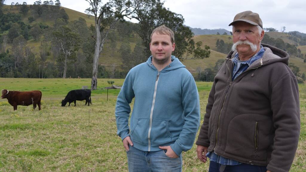 Des Dillon and his son James in front of the site where a paper crown road runs through the middle of their paddocks.