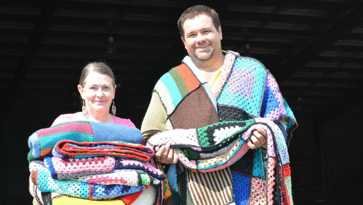 Denell’s Transport contractor Tyson Walker accepts 17 blankets from Deborah Brooks, crocheter of 26 years. Denell's transport the blankets down to the Wrap With Love centre several times a year. 
